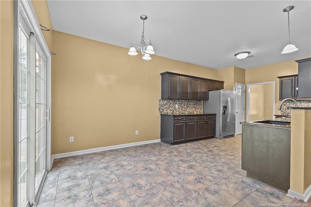 60 Hunters Way, Angier, NC 27501 - kitchen with dark brown cabinets, a sink, stainless steel refrigerator with ice dispenser, a notable chandelier, and backsplash