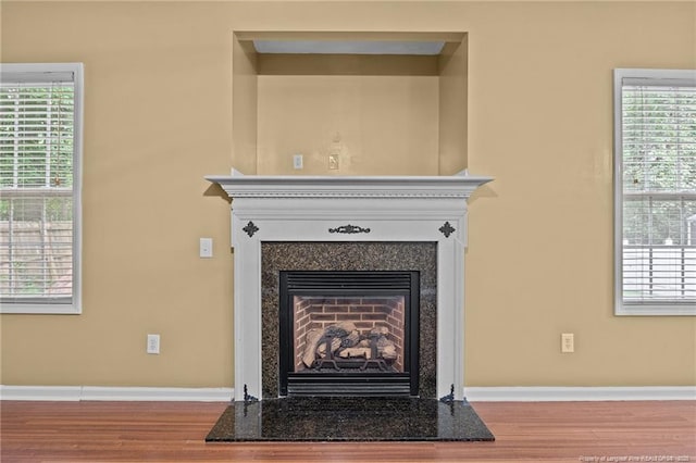 60 Hunters Way, Angier, NC 27501 - room details with baseboards, wood finished floors, and a fireplace with raised hearth