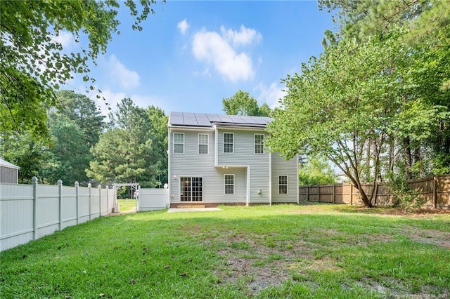 60 Hunters Way, Angier, NC 27501 - back of house featuring a yard, solar panels, and a fenced backyard