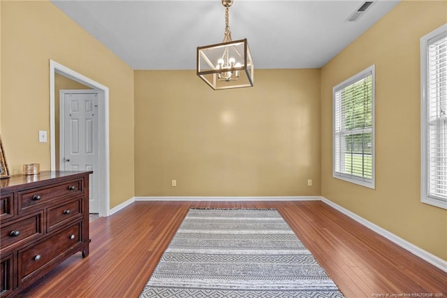 60 Hunters Way, Angier, NC 27501 - unfurnished dining area with dark wood-type flooring and a chandelier