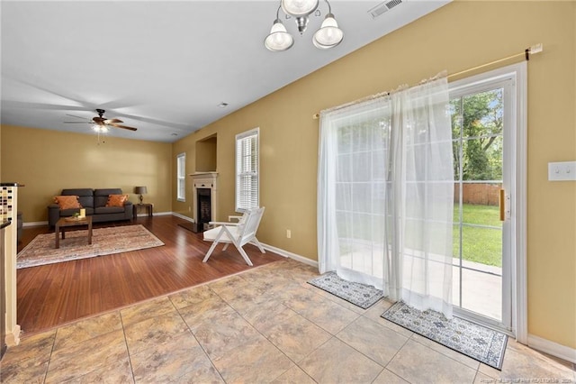 60 Hunters Way, Angier, NC 27501 - tiled living area with a ceiling fan and a fireplace