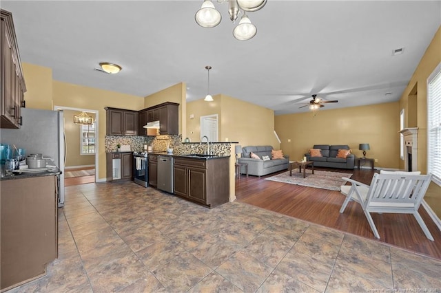 60 Hunters Way, Angier, NC 27501 - kitchen with stainless steel appliances, ceiling fan, dark brown cabinets, open floor plan, and decorative backsplash