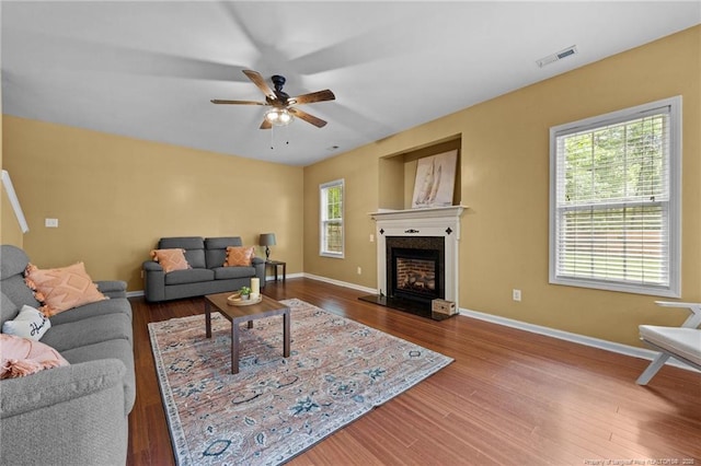 60 Hunters Way, Angier, NC 27501 - living area with a ceiling fan, wood finished floors, and a fireplace with raised hearth