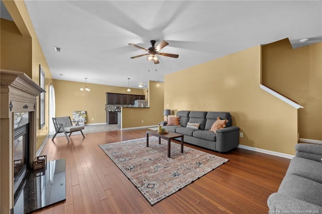 60 Hunters Way, Angier, NC 27501 - living area featuring a ceiling fan, wood finished floors, and a premium fireplace