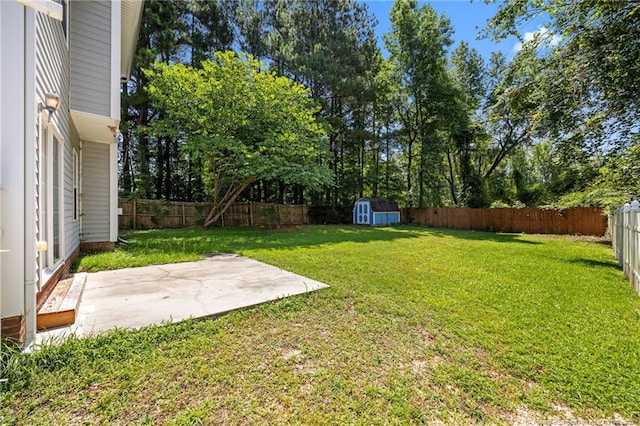60 Hunters Way, Angier, NC 27501 - fenced backyard featuring a patio area, a storage unit, and view of wooded area