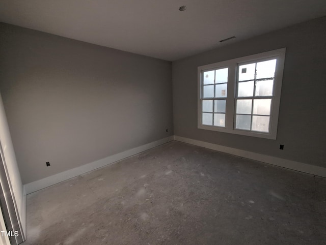 spare room featuring visible vents and baseboards