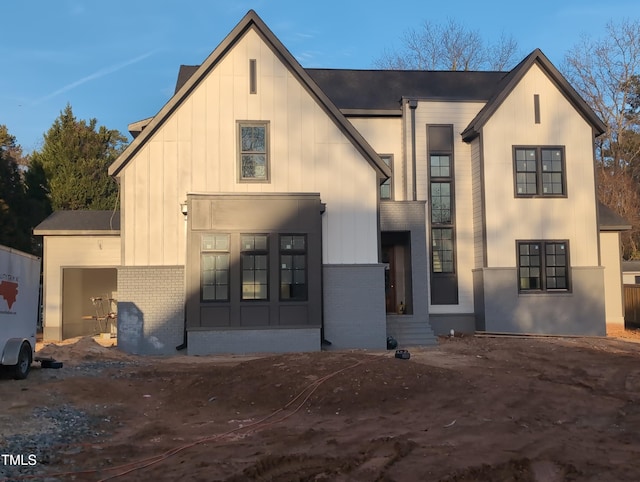 view of front of home with board and batten siding and brick siding