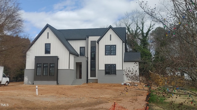 modern farmhouse style home with entry steps and board and batten siding