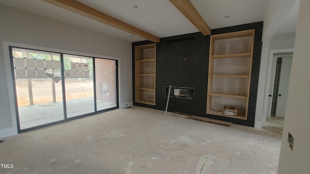 unfurnished living room with beamed ceiling and a premium fireplace