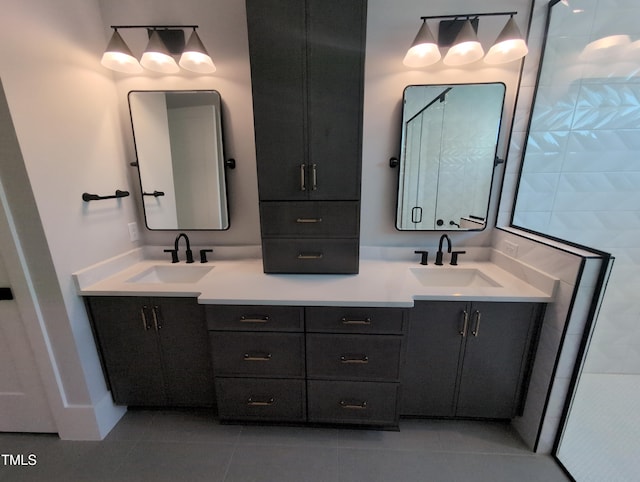 bathroom with tile patterned floors, a sink, and double vanity