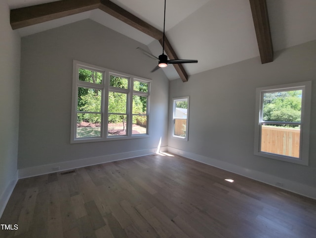 spare room with visible vents, vaulted ceiling with beams, and baseboards