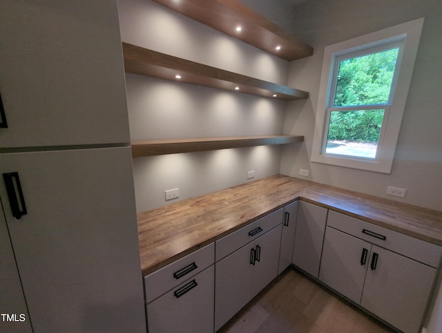 kitchen featuring white cabinets, recessed lighting, open shelves, wood finished floors, and butcher block countertops