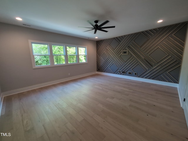 unfurnished room with recessed lighting, wood finished floors, a ceiling fan, and baseboards