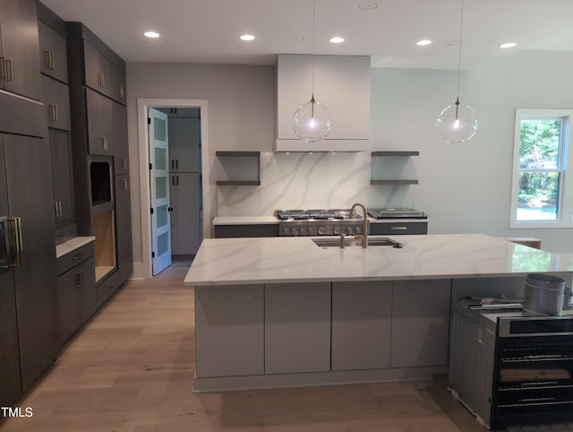 kitchen featuring high end refrigerator, recessed lighting, open shelves, and light stone countertops