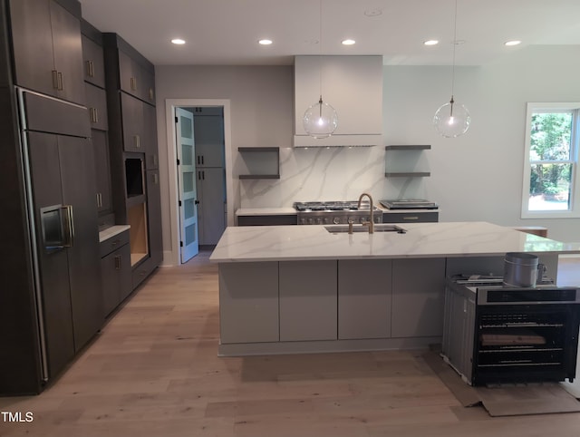 kitchen with open shelves, modern cabinets, a sink, and paneled fridge