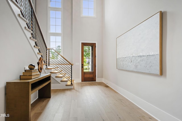 5812 Shawood Dr, Raleigh, NC 27609 - foyer entrance with stairway, light wood finished floors, a towering ceiling, and baseboards