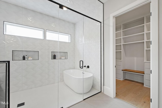 5812 Shawood Dr, Raleigh, NC 27609 - full bathroom with a stall shower, a walk in closet, and a soaking tub