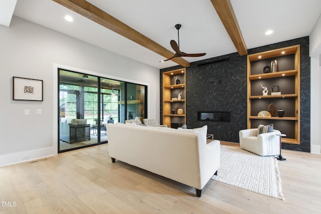 5812 Shawood Dr, Raleigh, NC 27609 - living room featuring beam ceiling, a ceiling fan, light wood-style flooring, a fireplace, and baseboards