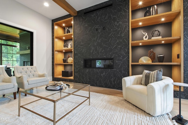 5812 Shawood Dr, Raleigh, NC 27609 - living area featuring a high end fireplace, wood finished floors, built in shelves, beam ceiling, and recessed lighting