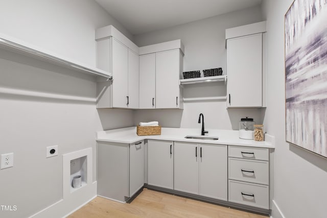 5812 Shawood Dr, Raleigh, NC 27609 - washroom featuring hookup for an electric dryer, light wood finished floors, and cabinet space