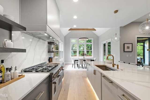 5812 Shawood Dr, Raleigh, NC 27609 - kitchen with range with two ovens, a sink, light wood finished floors, healthy amount of natural light, and recessed lighting