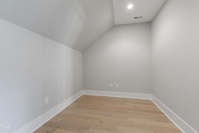 5812 Shawood Dr, Raleigh, NC 27609 - additional living space with vaulted ceiling, light wood-style flooring, and baseboards