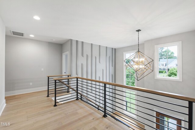5812 Shawood Dr, Raleigh, NC 27609 - corridor featuring an upstairs landing, a chandelier, wood finished floors, baseboards, and recessed lighting
