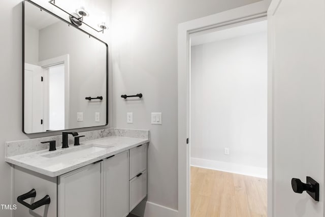 5812 Shawood Dr, Raleigh, NC 27609 - bathroom featuring wood finished floors, baseboards, and vanity
