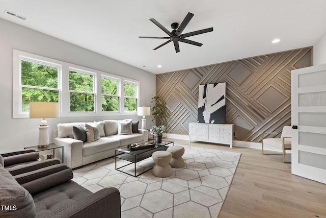 5812 Shawood Dr, Raleigh, NC 27609 - living room featuring an accent wall, a ceiling fan, light wood-type flooring, and recessed lighting