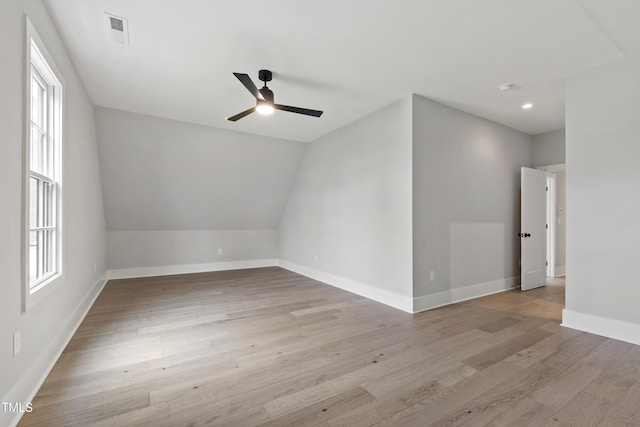5812 Shawood Dr, Raleigh, NC 27609 - spare room featuring a ceiling fan, healthy amount of natural light, light wood-style floors, baseboards, and vaulted ceiling