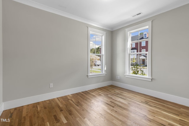 unfurnished room with crown molding and light hardwood / wood-style flooring