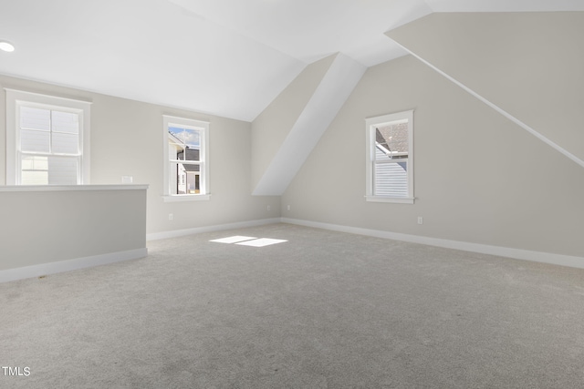 additional living space with lofted ceiling and light colored carpet