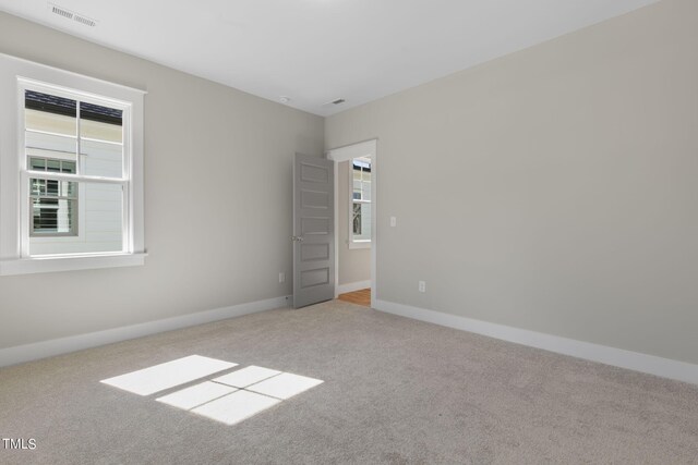 210 Colvard Farms Rd, Durham, NC 27713 - spare room featuring carpet flooring, baseboards, a wealth of natural light, and visible vents