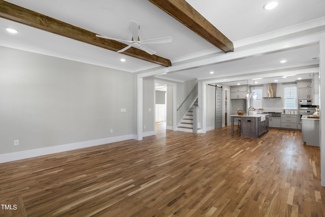 unfurnished living room featuring sink, beamed ceiling, crown molding, ceiling fan, and dark hardwood / wood-style flooring