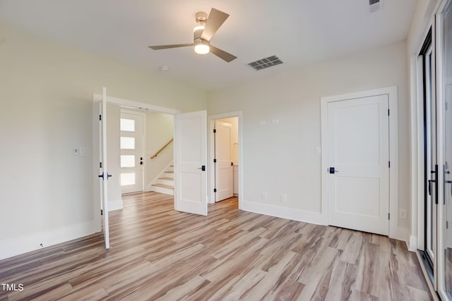 unfurnished bedroom with ceiling fan and light hardwood / wood-style floors