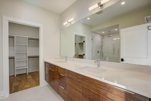 bathroom featuring vanity, an enclosed shower, and wood-type flooring