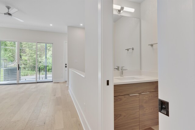 bathroom featuring vanity, ceiling fan, and hardwood / wood-style flooring