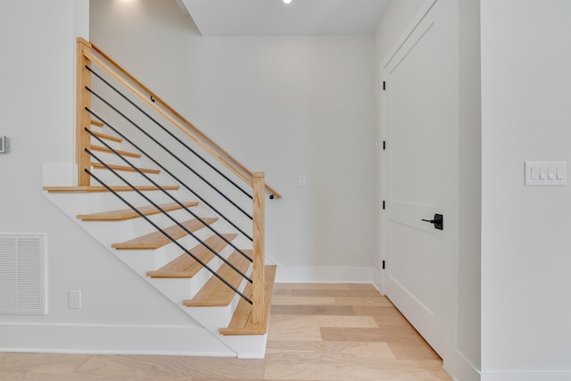 stairs featuring hardwood / wood-style flooring