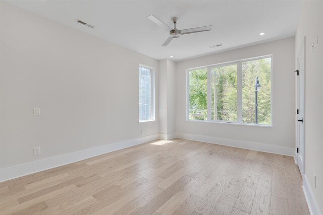 spare room featuring ceiling fan and light hardwood / wood-style floors