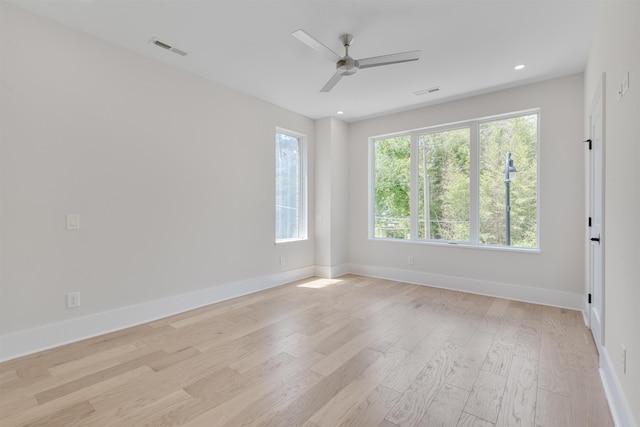 empty room featuring ceiling fan and light hardwood / wood-style floors