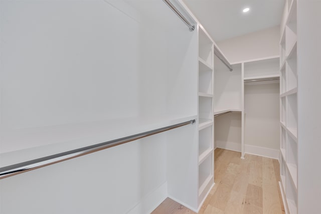 walk in closet with light wood-type flooring