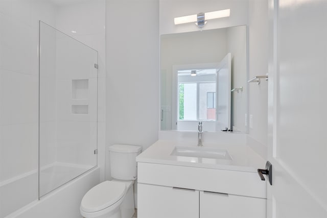 full bathroom with tiled shower / bath combo, vanity, and toilet