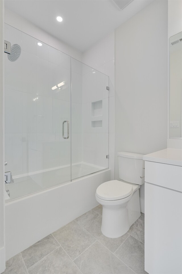 full bathroom with vanity, toilet, tile patterned floors, and enclosed tub / shower combo