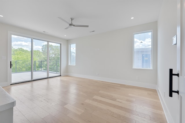 empty room featuring ceiling fan and light hardwood / wood-style floors