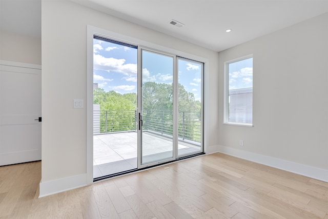 doorway to outside with light wood-type flooring