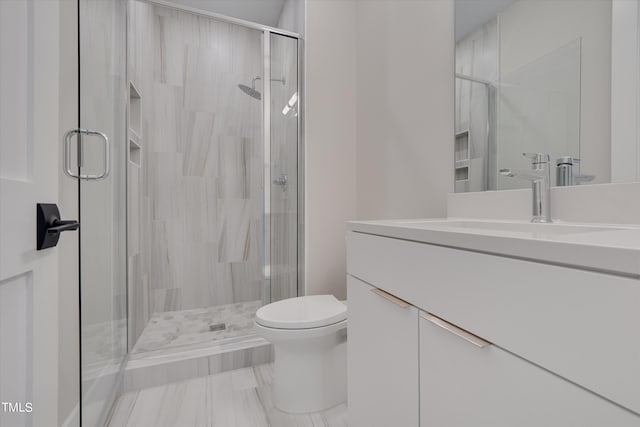 bathroom with vanity, toilet, and walk in shower