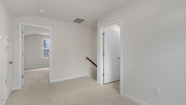 hall featuring light colored carpet, visible vents, vaulted ceiling, an upstairs landing, and baseboards