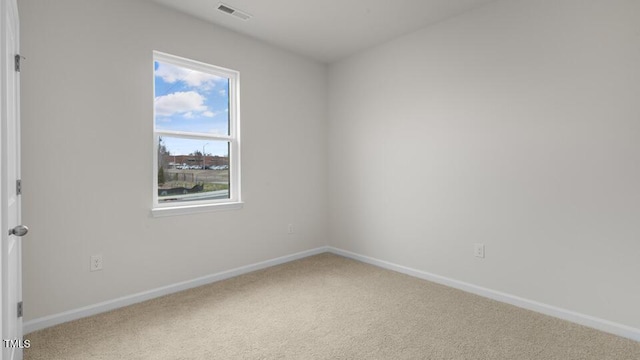 carpeted empty room with visible vents and baseboards