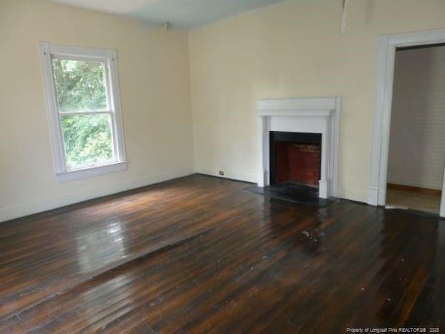 unfurnished living room featuring dark hardwood / wood-style flooring