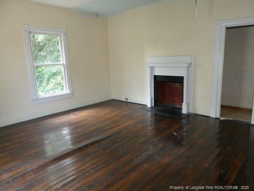 unfurnished living room featuring dark hardwood / wood-style flooring